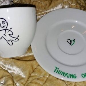 White Ceramic Cup and Saucer Set with Black and Green Design